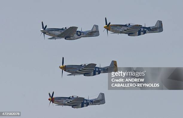 North American P-51 Mustangs fly over the National Mall during the Arsenal of Democracy, a WWII plane flyover for the 70th anniversary of V-E Day in...