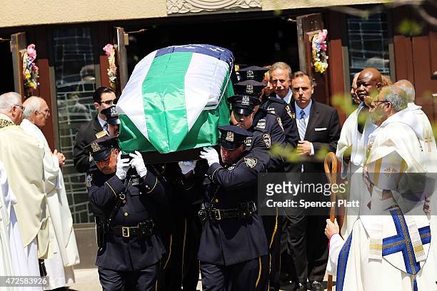 The casket for fallen New York City police officer Brian Moore is brought out of a Long Island church on May 8, 2015 in Seaford, New York. Officer...