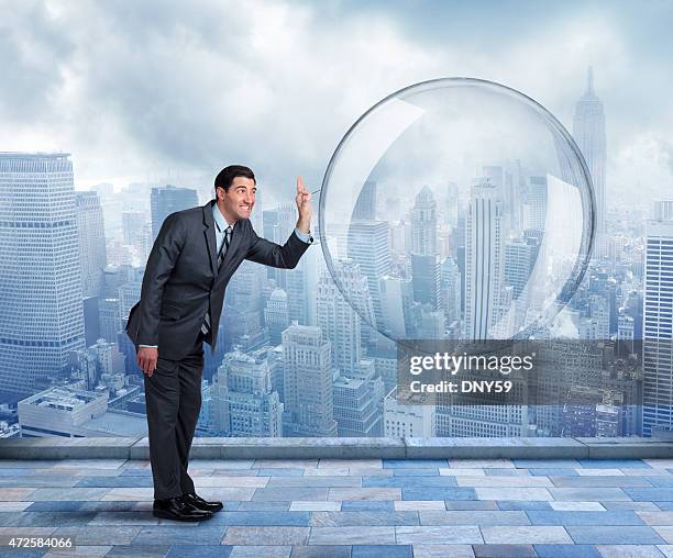 businessman about to pop a large bubble - bubble burst stock pictures, royalty-free photos & images