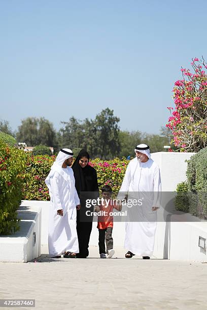 arab family enjoying their leisure time in park - saudi grandfather stock pictures, royalty-free photos & images