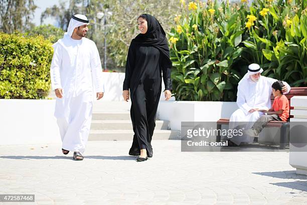 arab family enjoying their leisure time in park - arab man walking stock pictures, royalty-free photos & images