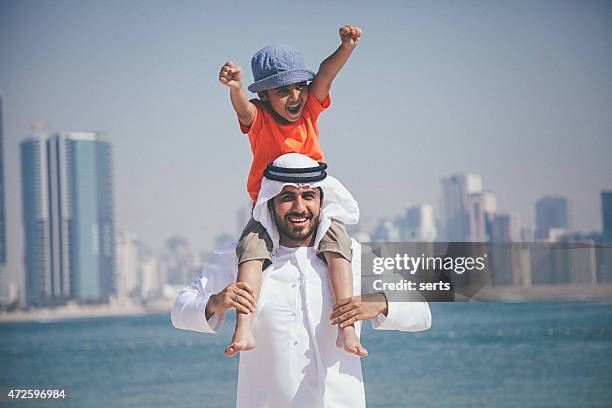 arab father and son having fun at beach - happy arab family on travel stock pictures, royalty-free photos & images