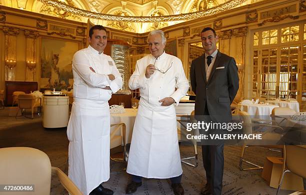 French chef Alain Ducasse poses with kitchen manager Dominique Lory and restaurant manager Michel Lang in the "Louis XV" new dining restaurant in the...
