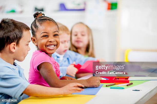 children playing at daycare - preschool stock pictures, royalty-free photos & images
