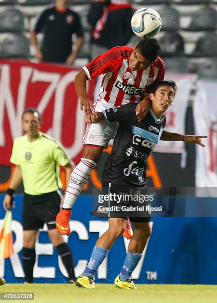 David Barbona of Estudiantes jumps to head the ball over Fabian Sambueza of Temperley during a match between Estudiantes and Temperley as part of...