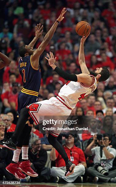 Nikola Mirotic of the Chicago Bulls gets off a shot against James Jones of the Cleveland Cavaliers in Game Three of the Eastern Conference Semifinals...