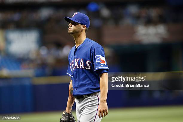 Pitcher Alexander Claudio of the Texas Rangers walks back to the dugout after being taken off the mound by manager Jeff Banister after allowing a...
