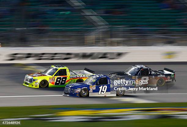 Matt Crafton, driver of the Slim Jim/Menards Toyota, leads Tyler Reddick, driver of the BBR Music Group Ford, and Ryan Newman, driver of the...