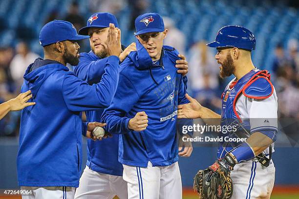 Aaron Sanchez of the Toronto Blue Jays get high fives from Jose Reyes Mark Buehrle and Russell Martin as the Toronto Blue Jays defeat the Boston Red...