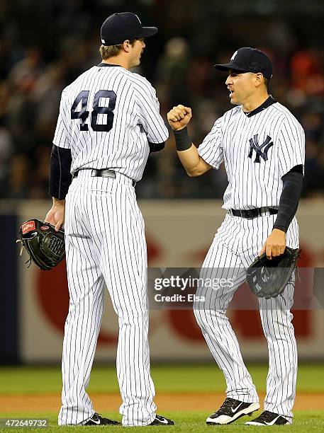 Andrew Miller and Jacoby Ellsbury of the New York Yankees celebrate the win over the Baltimore Orioles on May 8, 2015 at Yankee Stadium in the Bronx...