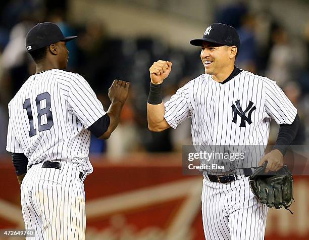 Didi Gregorius and Jacoby Ellsbury of the New York Yankees celebrate the win over the Baltimore Orioles on May 8, 2015 at Yankee Stadium in the Bronx...