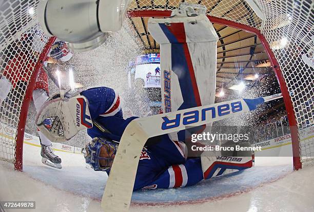 Henrik Lundqvist of the New York Rangers gives up a third period goal to Curtis Glencross of the Washington Capitals in Game Five of the Eastern...