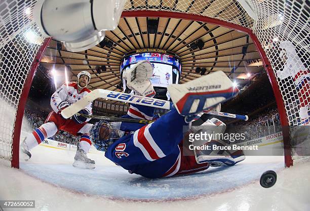 Brooks Laich of the Washington Capitals watches a shot by Curtis Glencross enter the net past Henrik Lundqvist of the New York Rangers in Game Five...