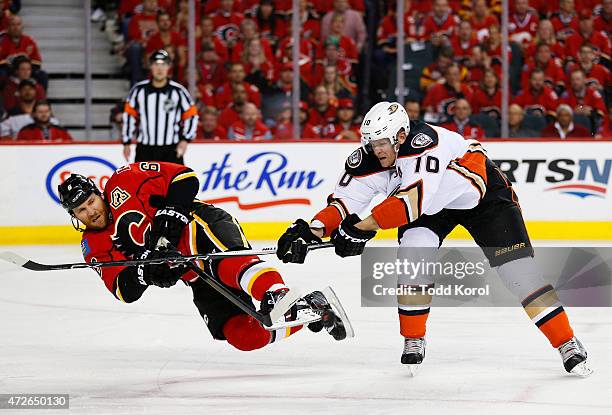 Dennis Wideman of the Calgary Flames is sent flying by Corey Perry of the Anaheim Ducks in Game Four of the Western Conference Semifinals during the...