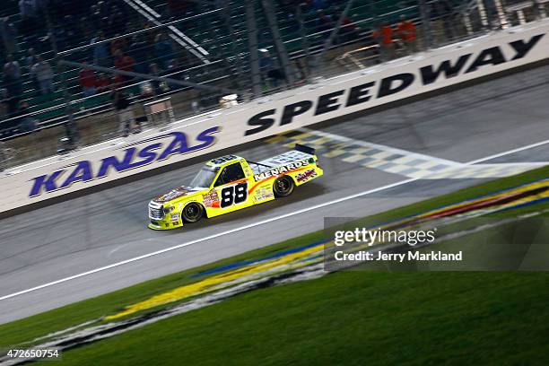 Matt Crafton, driver of the Slim Jim/Menards Toyota, takes the checkered flag to win the NASCAR Camping World Truck Series Toyota Tundra 250 at...