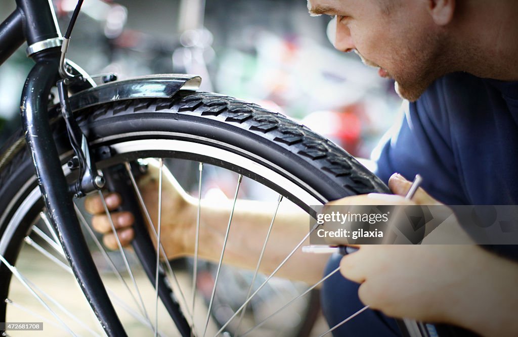Bike mechanic repairing a wheel