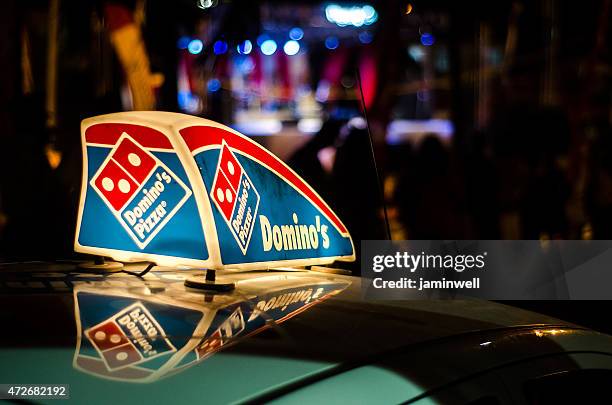 dominos pizza car illuminated sign - dominoes stock pictures, royalty-free photos & images