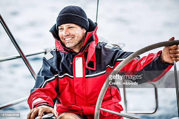 happy skipper on sailboat - captain yacht stock pictures, royalty-free photos & images