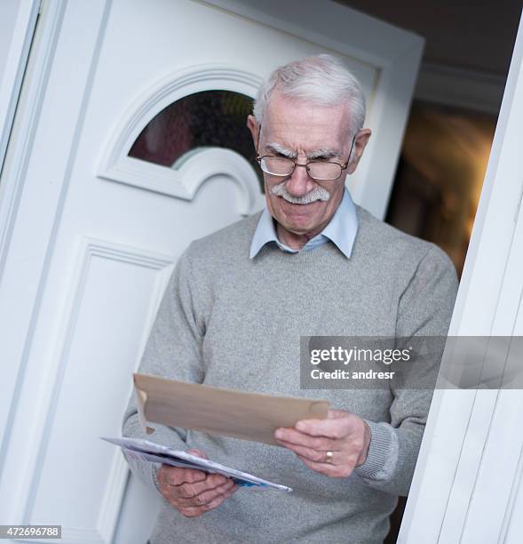 retired man checking the mail - retirement invitation stock pictures, royalty-free photos & images