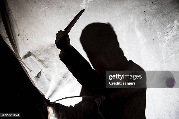 silhouette of killer with knife in action - assassination stock pictures, royalty-free photos & images