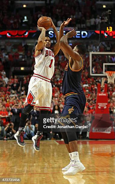 Derrick Rose of the Chicago Bulls takes the game-winning three-point shot over Tristan Thompson of the Cleveland Cavaliers in Game Three of the...