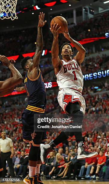 Derrick Rose of the Chicago Bulls shoots over Iman Shumpert of the Cleveland Cavaliers on his way to a game-high 30 points in Game Three of the...