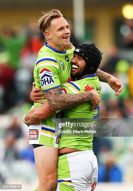 Blake Austin and Jordan Rapana of the Raiders celebrate a try by Rapana during the round nine NRL match between the Canberra Raiders and the GOld...