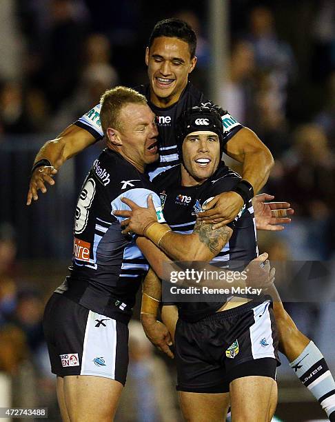 Luke Lewis of the Sharks celebrates his try with Valentine Holmes and Michael Ennis during the round nine NRL match between the Sharks and the...