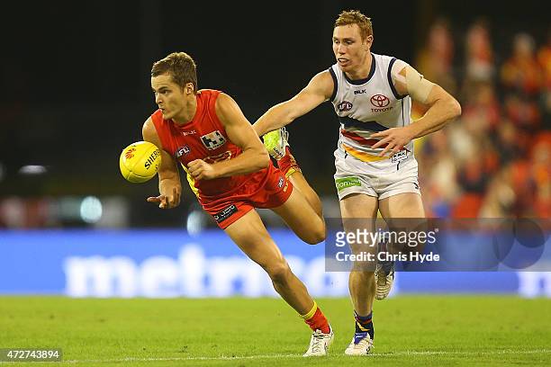 Kade Kolodjashnij of the Suns handballs during the round six AFL match between the Gold Coast Suns and the Adelaide Crows at Metricon Stadium on May...