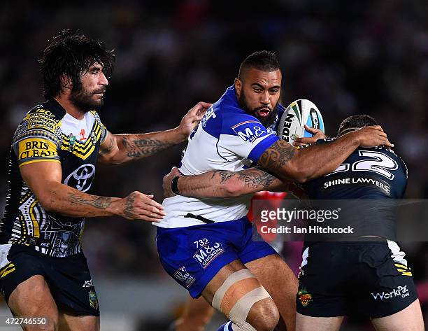 Frank Pritchard of the Bulldogs is tackled by Ethan Lowe and James Tamou of the Cowboysduring the round nine NRL match between the North Queensland...