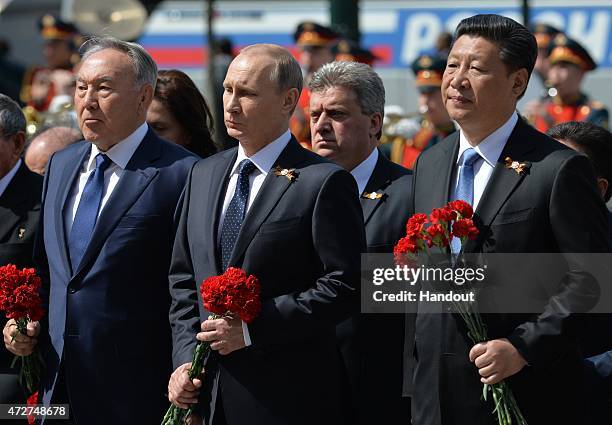 In this handout image supplied by Host photo agency / RIA Novosti, Russian President Vladimir Putin, 2nd right, President of the People's Republic of...