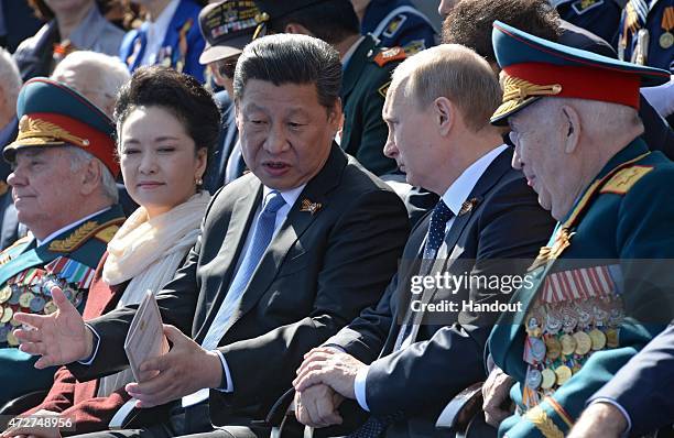 In this handout image supplied by Host photo agency / RIA Novosti, President Vladimir Putin, second left, and President of People's Republic of China...