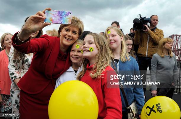 Scottish First Minister and Leader of the Scottish National Party , Nicola Sturgeon takes a selfie photograph with local children after posing for...