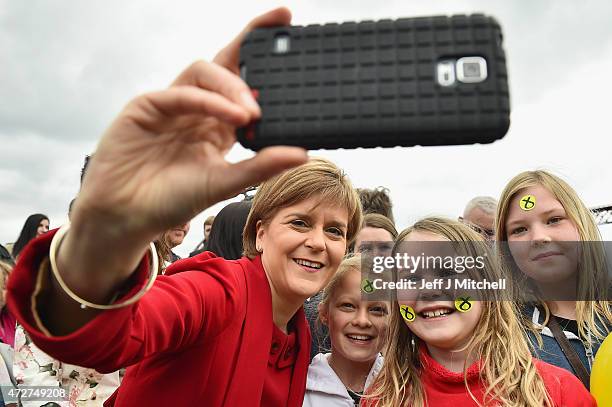 First Minister and leader of the SNP Nicola Sturgeon takes a selfie with some young supporters after being joined by the newly elected members of...