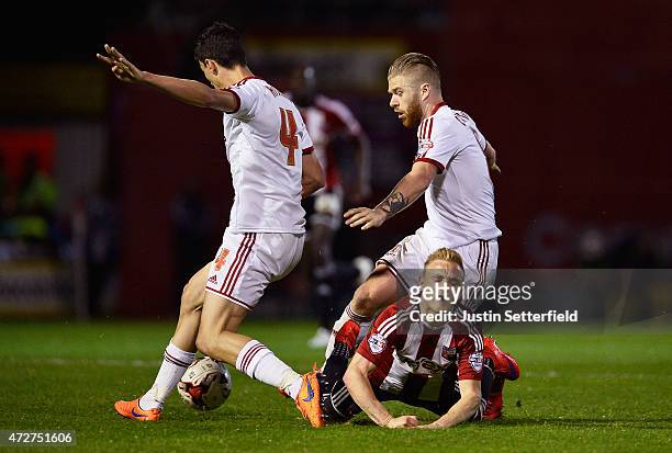 Alex Pritchard of Brentford is caught up between Adam Clayton and Daniel Ayala of Middlesbrough During the Sky Bet Championship Playoff Semi-Final at...