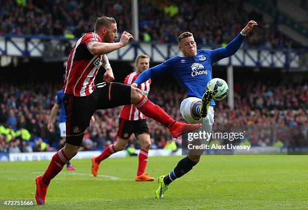 Ross Barkley of Everton is challenged by Connor Wickham of Sunderland during the Barclays Premier League match between Everton and Sunderland at...