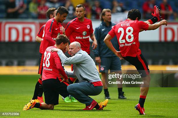 Head coach Thomas Schaaf of Frankfurt talks to Makoto Hasebe prior to the Bundesliga match between Eintracht Frankfurt and 1899 Hoffenheim at...