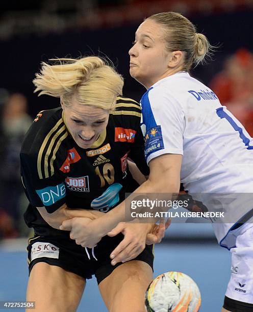 Norway's Gro Hammerseng-Edin fights for the ball with Russian Daria Dmitrieva during the EHF Women's Champions League Final Four semi-final match of...