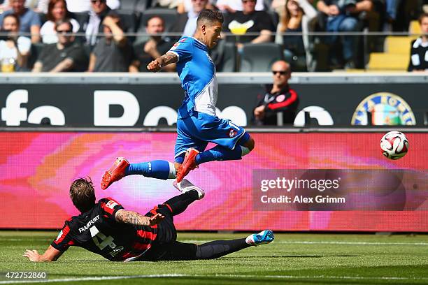 Roberto Firmino of Hoffenheim is challenged by Marco Russ of Frankfurt during the Bundesliga match between Eintracht Frankfurt and 1899 Hoffenheim at...