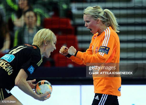 Norway's goalkeeper Sandra Toft celebrates with her teammate Gro Hammerseng-Edin as she saved a penalty of Russia's Olga Akopian during the EHF...