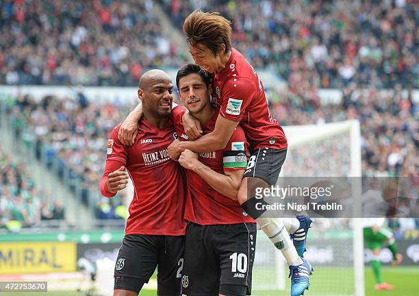 Lars Stindl of Hannover celebrates scoring his goal with Jimmy Briand and Hiroshi Kiyotake during the Bundesliga match between Hannover 96 and SV...
