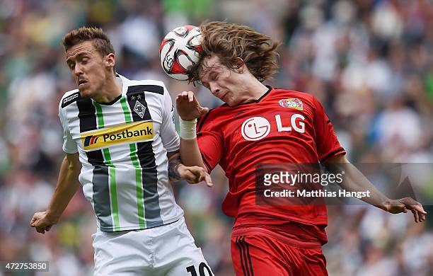 Max Kruse of Gladbach jumps for a header with Tin Jedvaj of Leverkusen during the Bundesliga match between Borussia Moenchengladbach and Bayer 04...