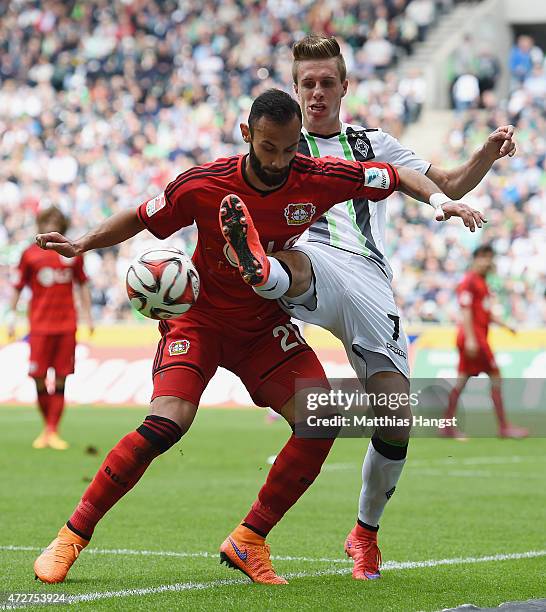 Oemer Toprak of Leverkusen and Patrick Herrmann of Gladbach compete for the ball during the Bundesliga match between Borussia Moenchengladbach and...