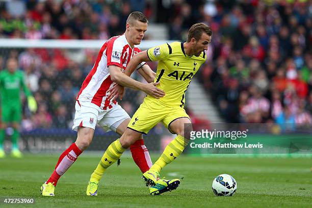 Harry Kane of Tottenham Hotspur is closed down by Ryan Shawcross of Stoke City during the Barclays Premier League match between Stoke City and...