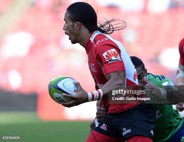 Courtnall Skosan of the Lions offloads in the tackle during the Super Rugby match between Emirates Lions and Highlanders at Emirates Airline Park on...