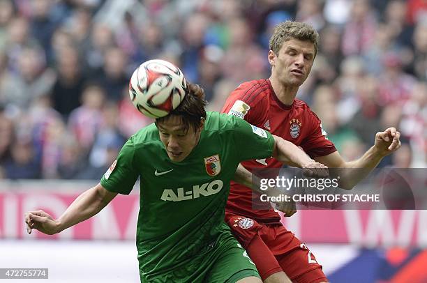 Bayern Munich's striker Thomas Mueller and Augsburg's Korean defender Hong Jeong-ho vie for the ball during the German first division Bundesliga...
