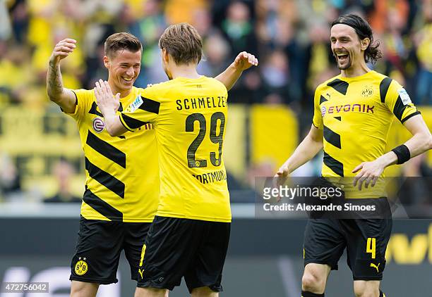 May 09: Erik Durm of Borussia Dortmund celebrates scoring the goal to the 2:0 together with his team mates Marcel Schmelzer and Neven Subotic during...