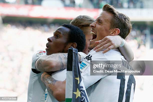 Ibrahima Traore of Borussia Moenchengladbach celebrates scoring the third goal of the game with team mates during the Bundesliga match between...