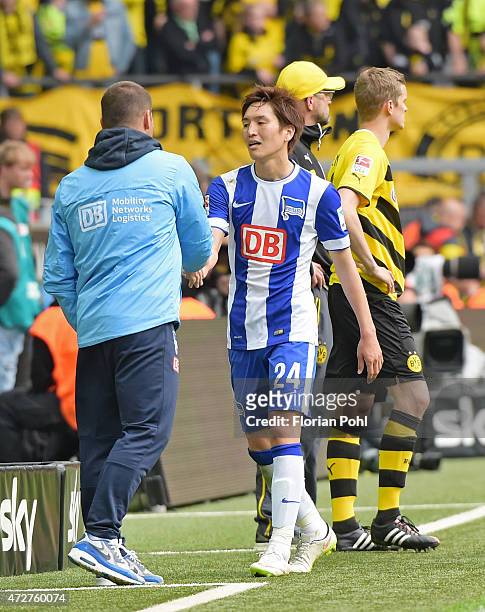 Coach Pal Dardai and Genki Haraguchi of Hertha BSC klatschen sich ab during the game between Borussia Dortmund and Hertha BSC on May 9, 2015 in...
