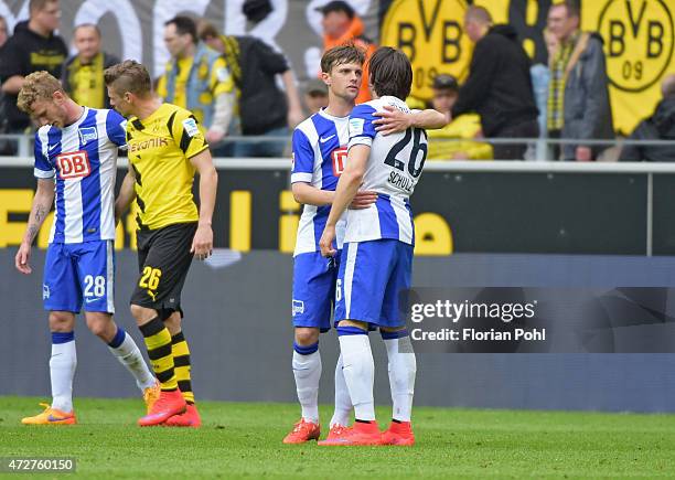 Valentin Stocker and Nico Schulz of Hertha BSC hug during the game between Borussia Dortmund and Hertha BSC on May 9, 2015 in Dortmund, Germany.